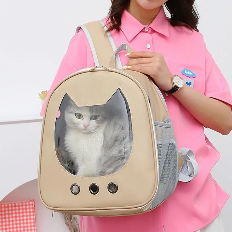 Person holding a beige pet backpack with a cat inside, wearing a pink shirt.