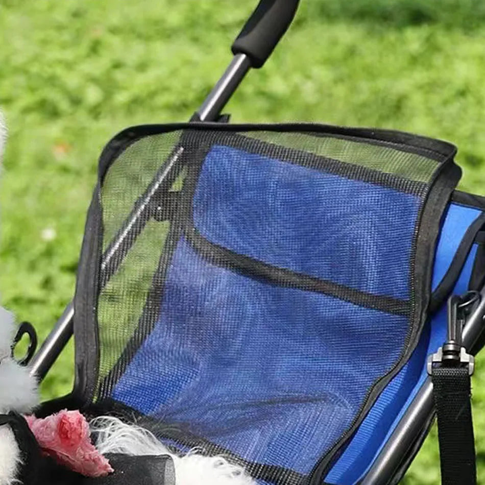 Blue pet stroller with a mesh cover on a grassy background
