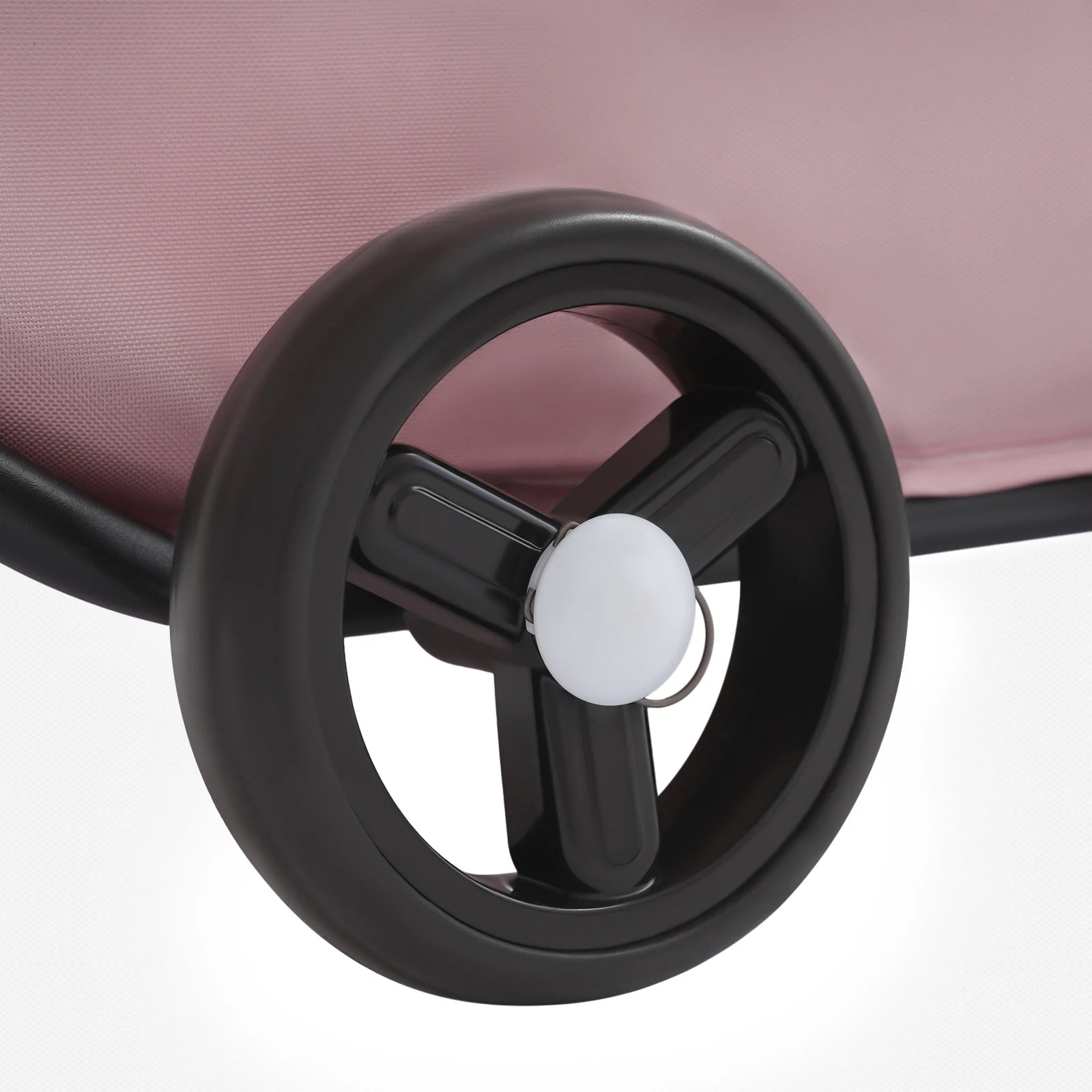Close-up of a suitcase wheel on a light pink background
