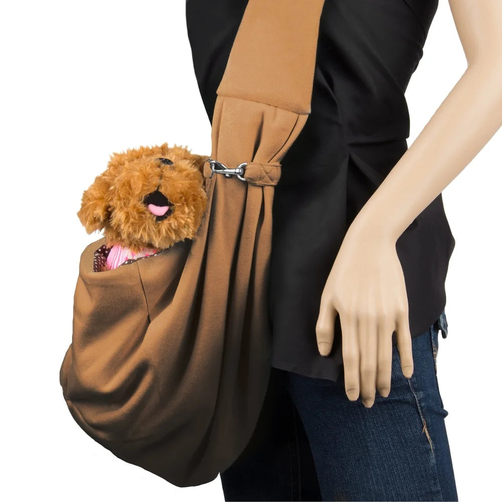 Person holding a brown pet sling with a plush dog toy inside on a white background
