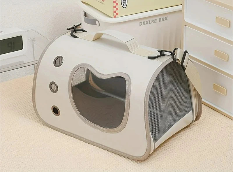 Pet carrier shaped like a spaceship on a light-colored surface