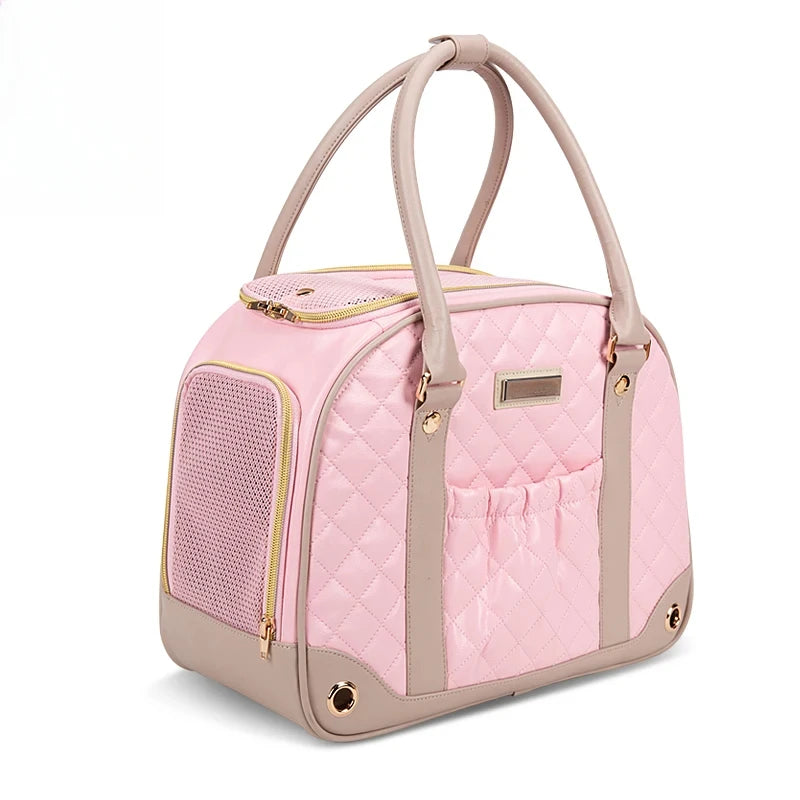 Pink pet carrier with beige accents on a white background