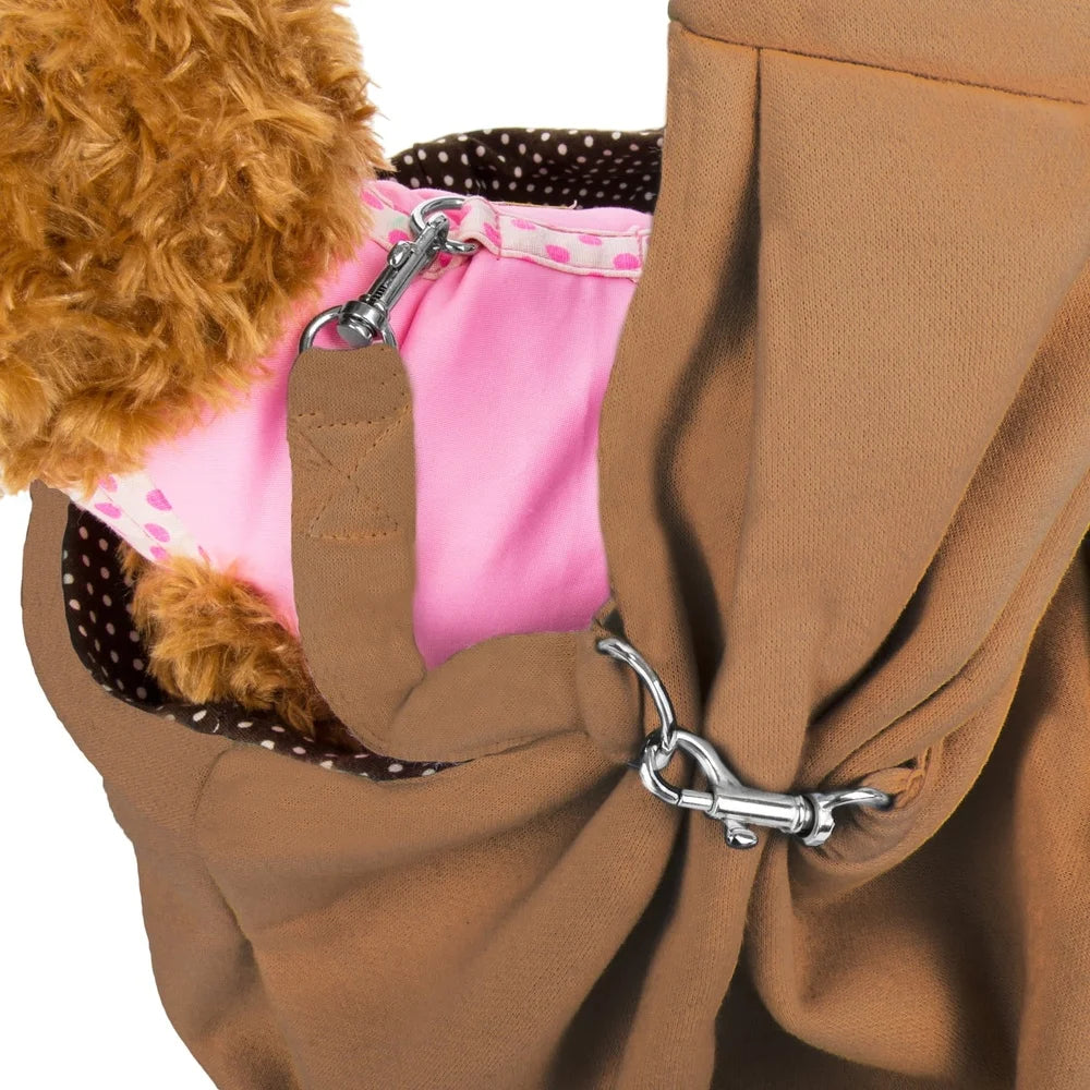 Brown dog carrier with a pink dog coat and visible straps on a white background