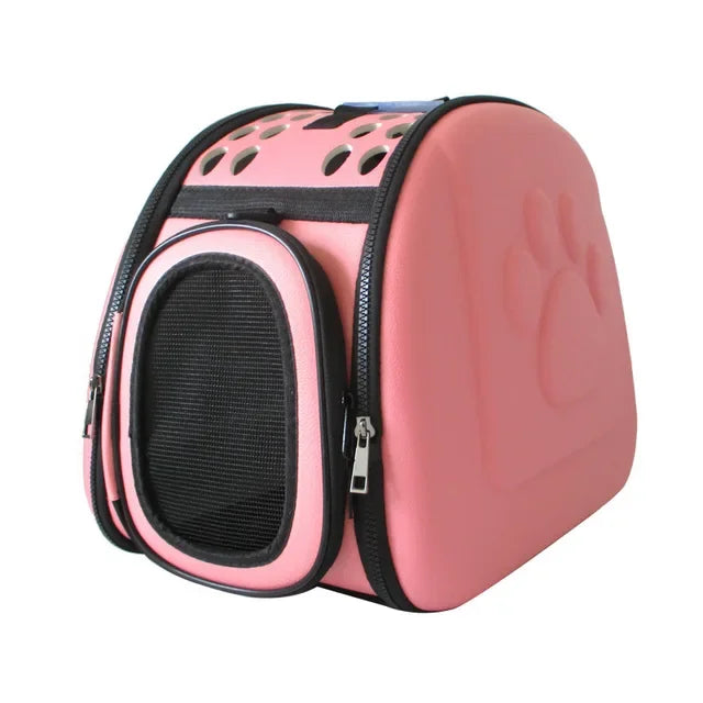 Pink pet carrier with black accents on a white background