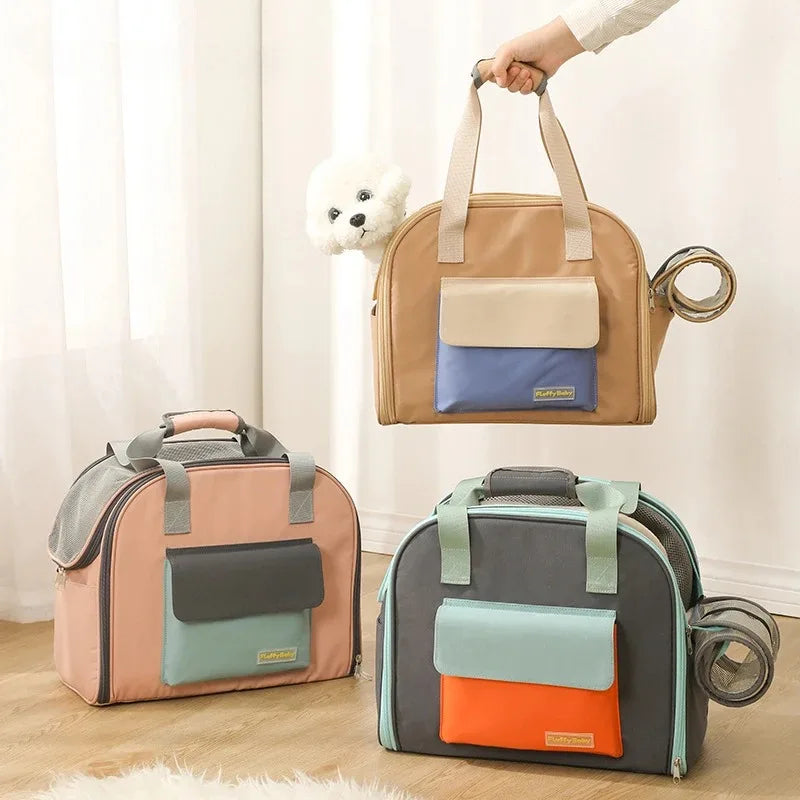 Three pet carriers in different colors with a hand holding one of them.