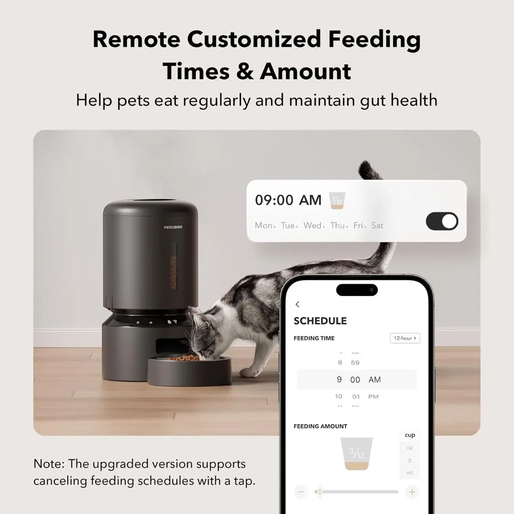 Pet feeder with smartphone app for remote customized feeding times and amount, featuring a cat eating.