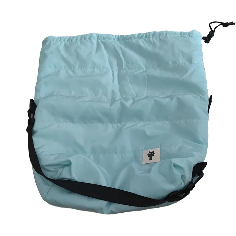 Light blue drawstring bag with black straps on a white background