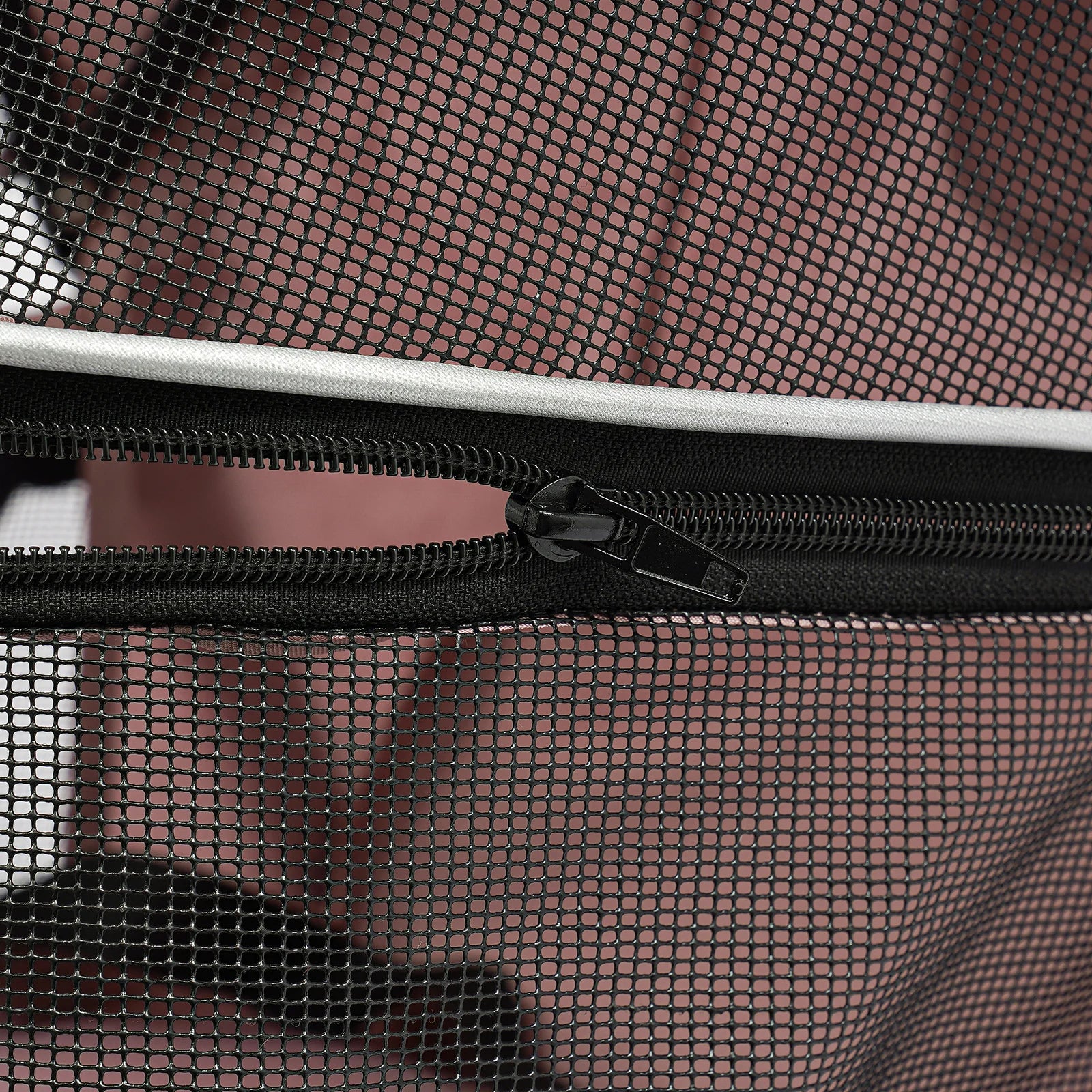 Close-up of a black zipper on a mesh bag with a blurred background
