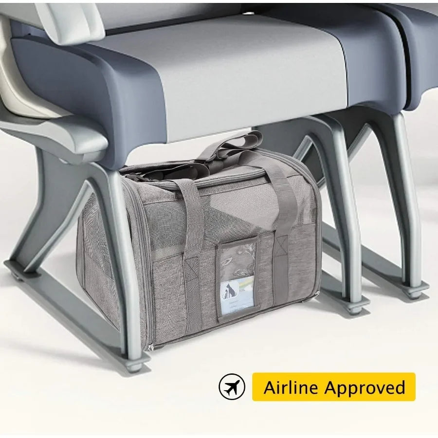 Gray pet carrier under an airplane seat with 'Airline Approved' label.