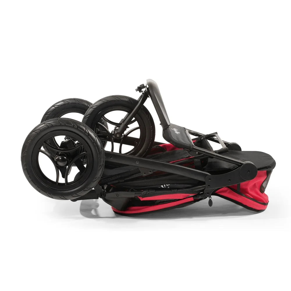 Folded black and red stroller on a white background