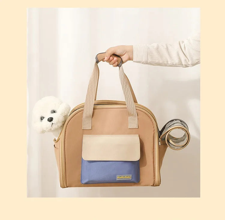 Beige and blue pet carrier with a small white dog inside, held by a person against a light background.