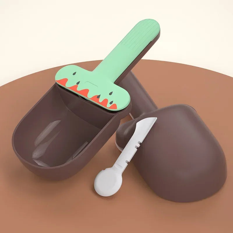 Pet bowl set with a green dinosaur-shaped handle on a brown background