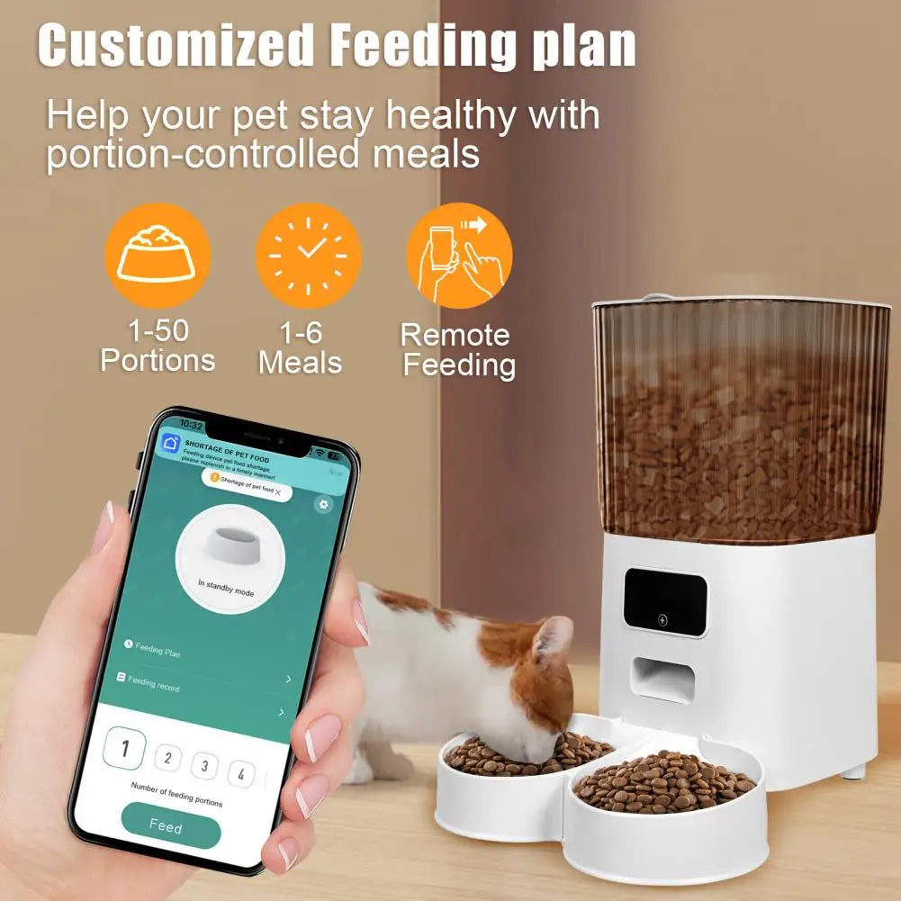 Pet feeding system with smartphone app and two bowls of food on a wooden surface.