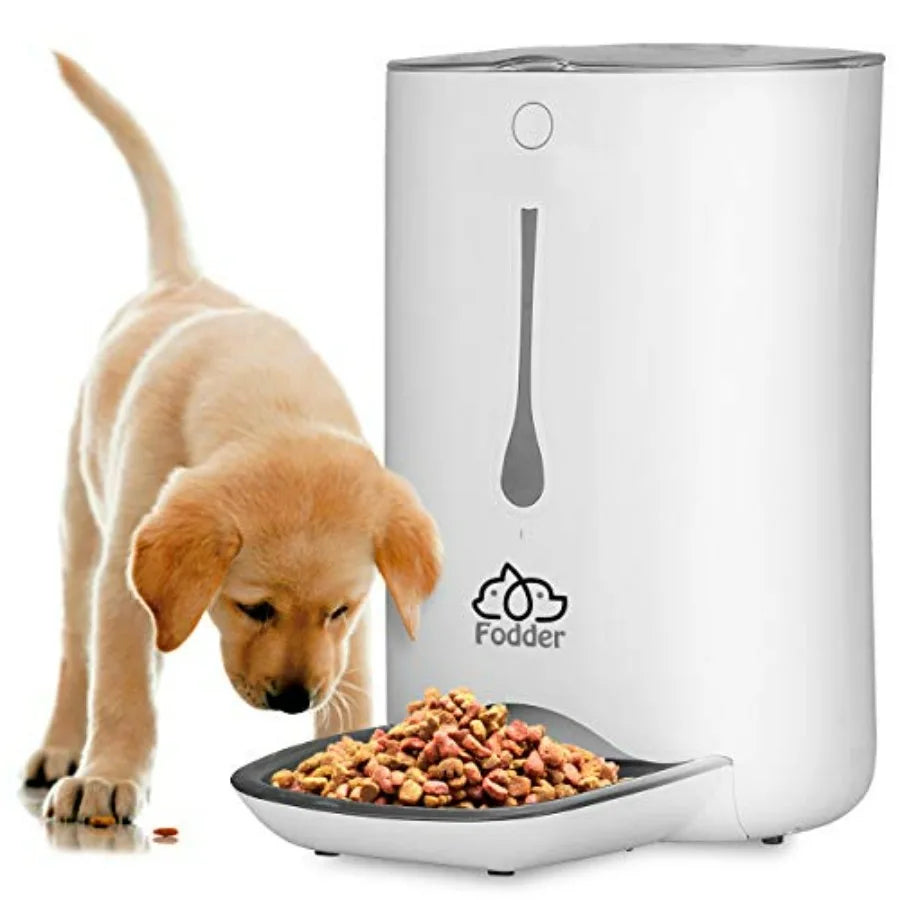 White pet food dispenser with a bowl of kibble and a puppy next to it, featuring the 'Fodder' brand.