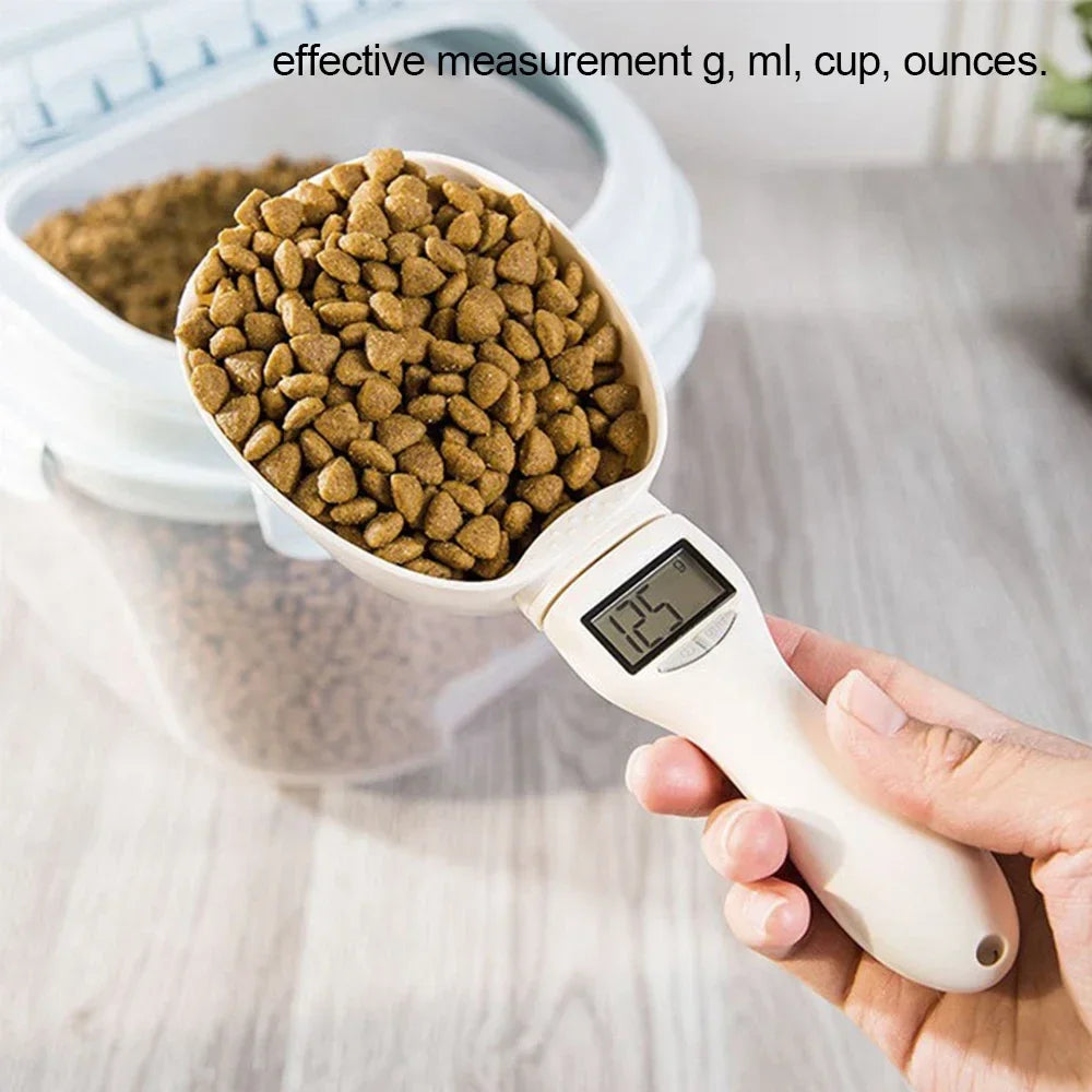 Digital pet food measuring scoop with a container of kibble and digital display showing measurement.