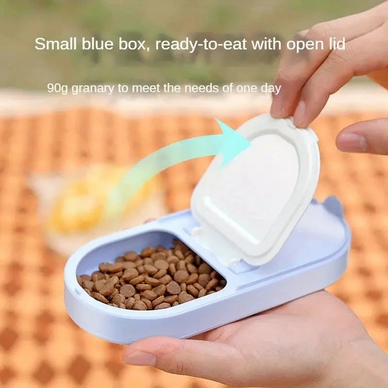 Small blue box with pet food and open lid held by a hand, outdoor background