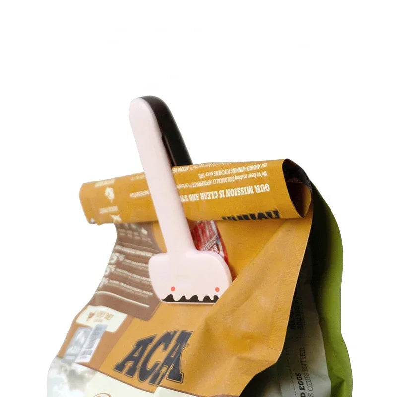 Small white shark-shaped tool on a yellow paper bag with text