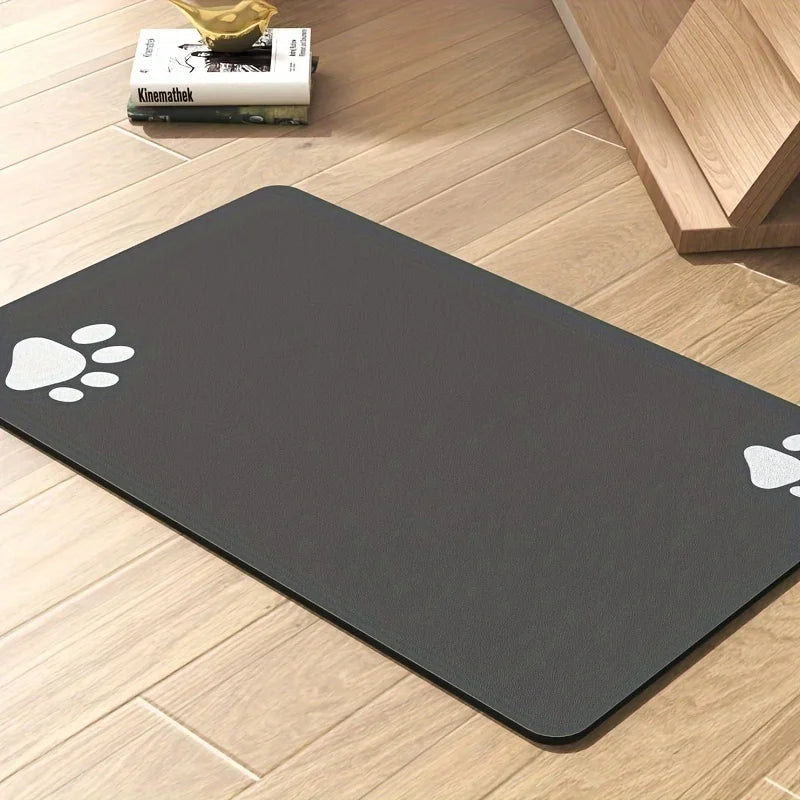 Black mat with white paw prints on a wooden floor