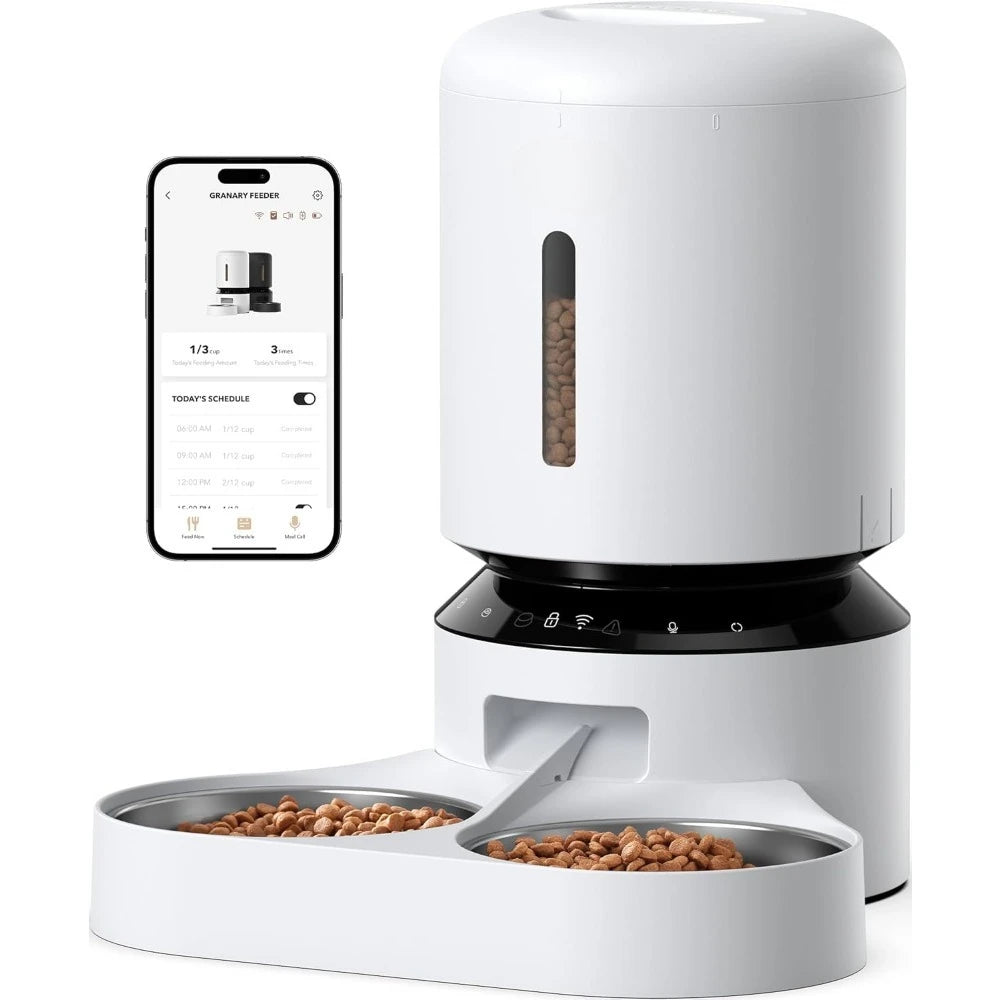 White pet food dispenser with two bowls and a smartphone displaying an app interface.