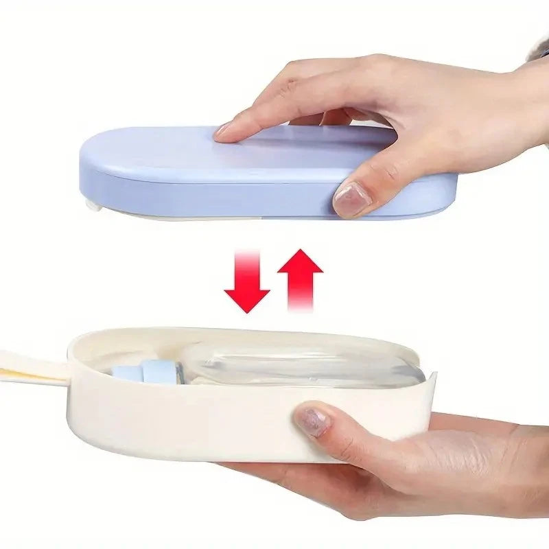 Two hands holding a small electronic device with a lid, showing how to open it.