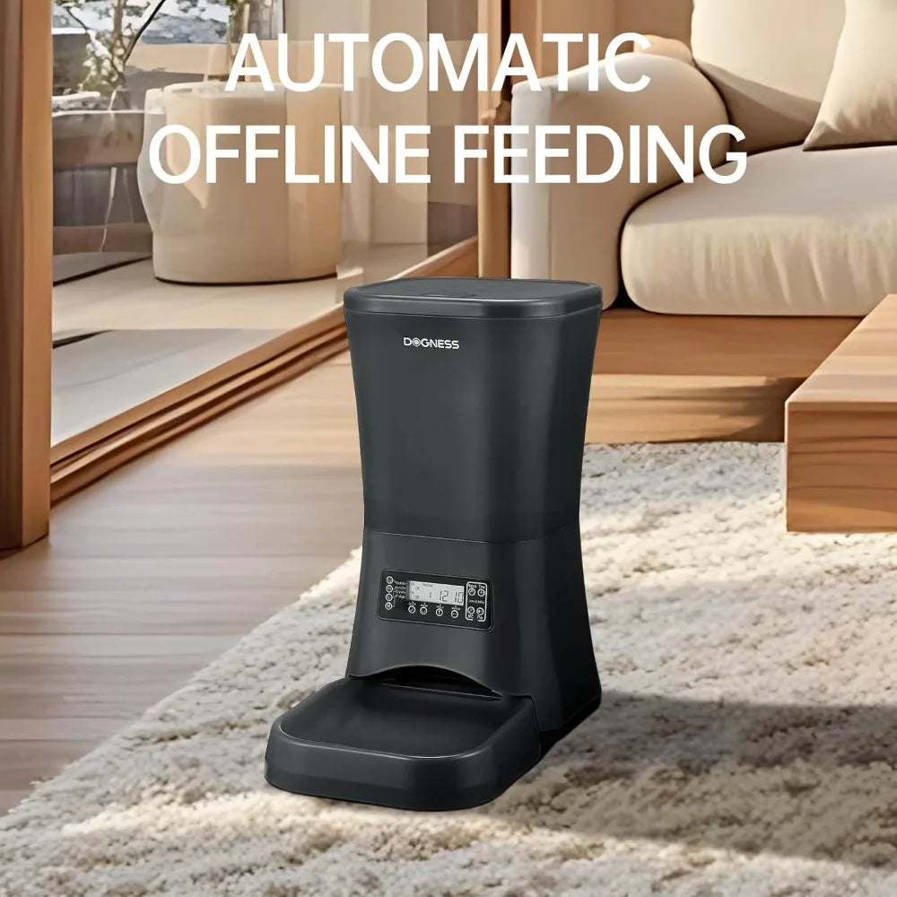 Black automatic offline pet feeder on a carpeted floor with a living room background.