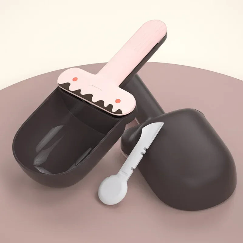 Black pet grooming tool set with pink handle and white scoop on a beige background