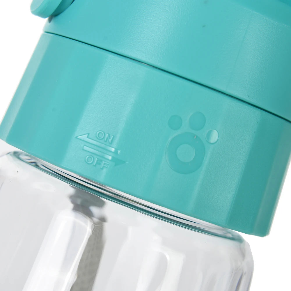 Close-up of a turquoise lid with paw print design on a clear bottle.